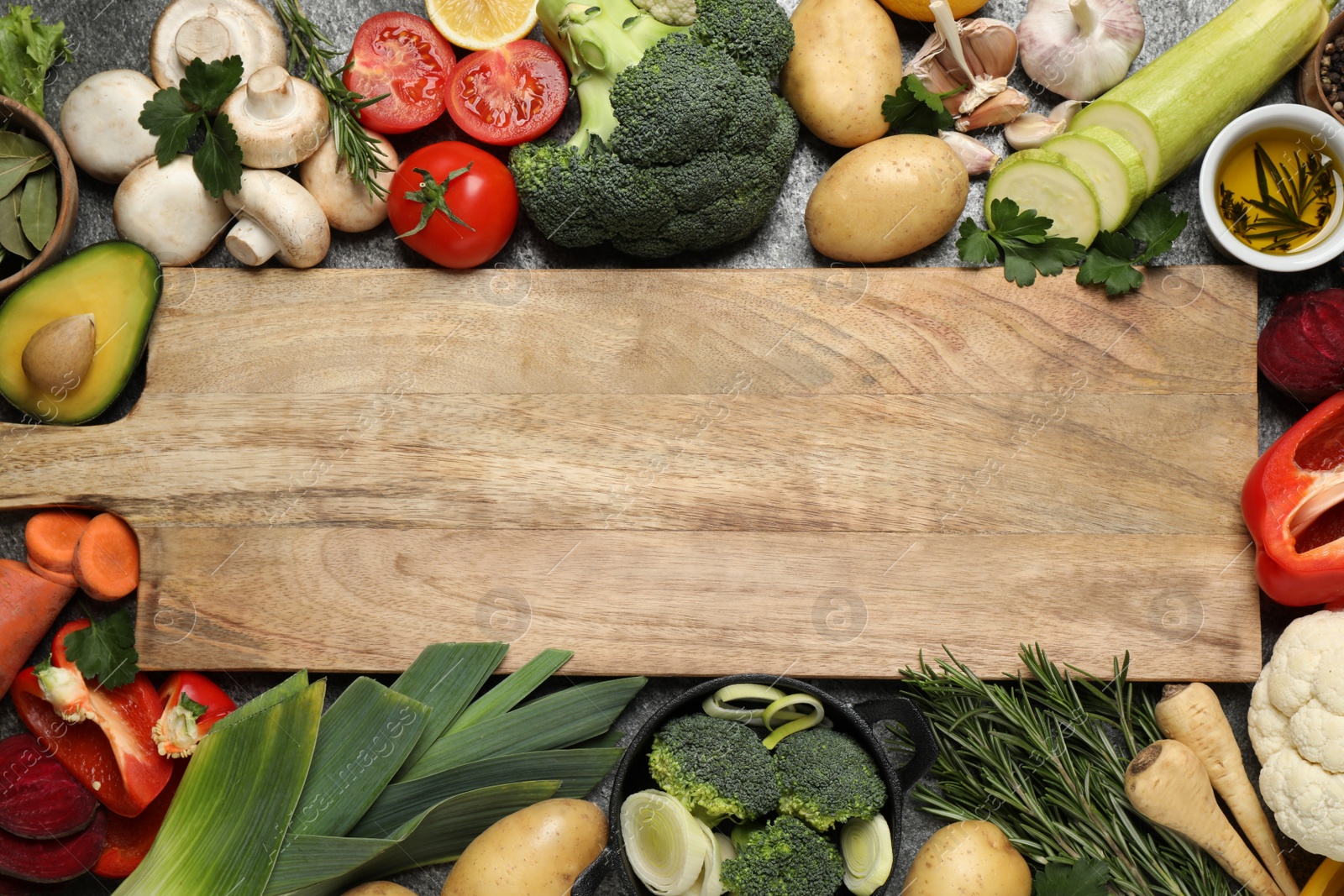 Photo of Fresh products and wooden board with space for text, flat lay. Healthy cooking