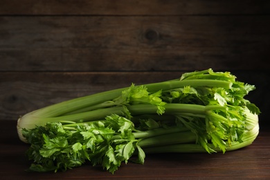 Fresh ripe green celery on wooden table. Space for text