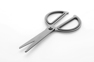 Photo of Pair of sharp scissors on white background