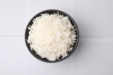 Photo of Bowl of delicious rice on white table, top view