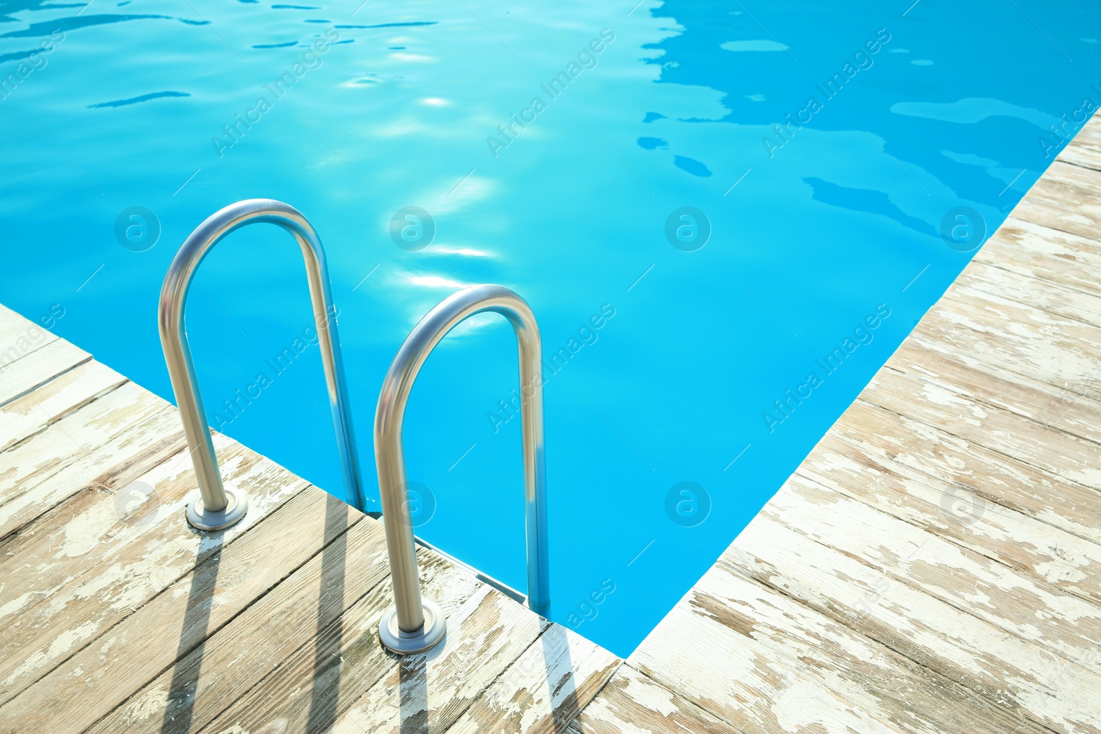 Photo of Ladder with grab bars in outdoor swimming pool