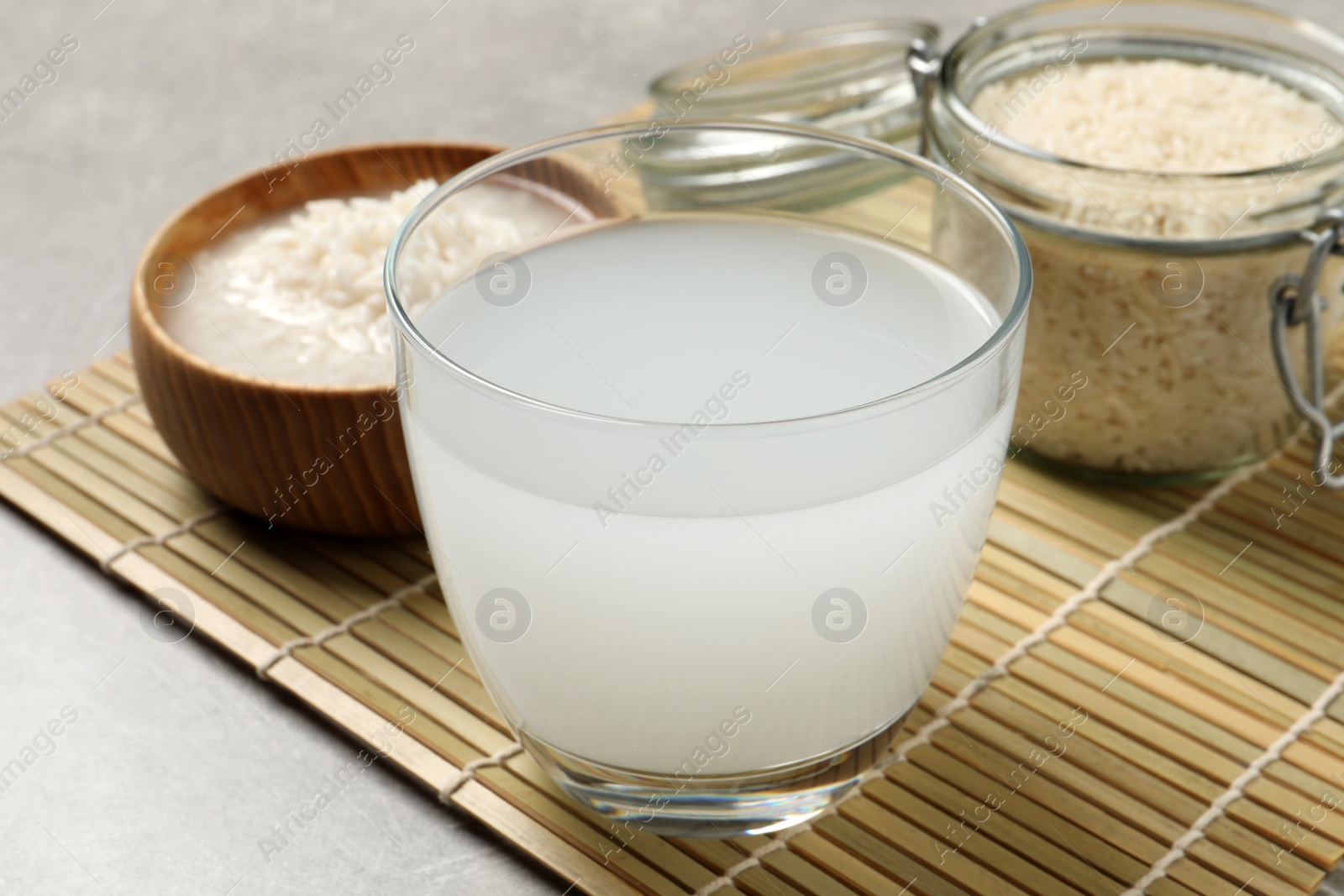 Photo of Glass with natural rice water on bamboo mat