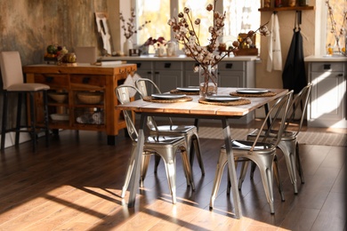 Stylish kitchen interior with dining table and chairs