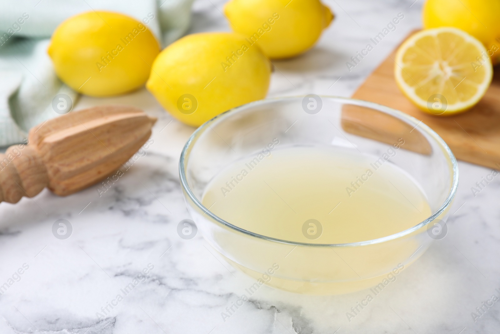 Photo of Freshly squeezed lemon juice on white marble table