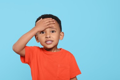 Photo of Emotional African-American boy on turquoise background. Space for text