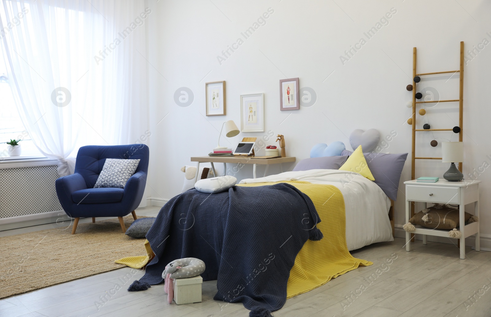 Photo of Modern teenager's room interior with bed and armchair