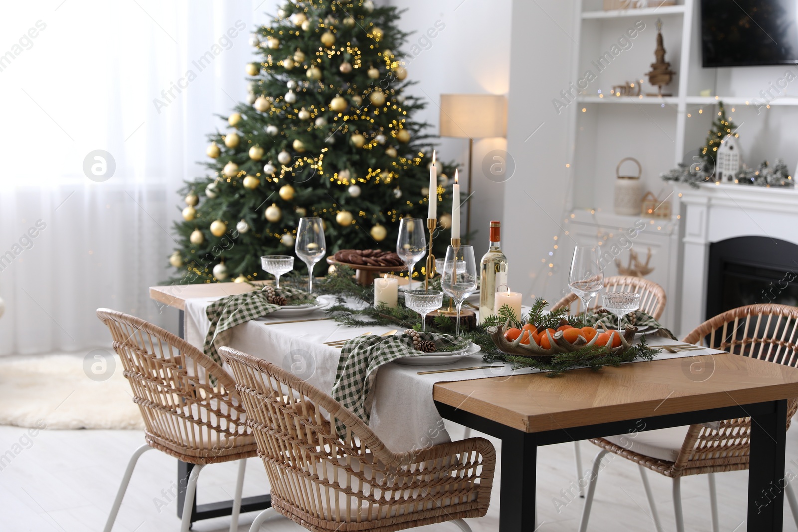 Photo of Christmas table setting with festive decor and dishware in living room