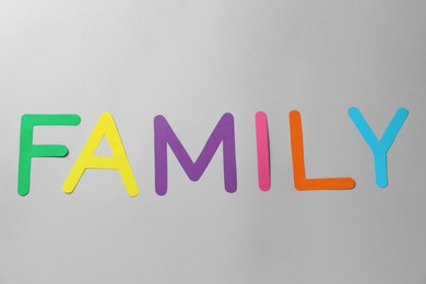 Photo of Word Family made of colorful paper letters on grey background, flat lay