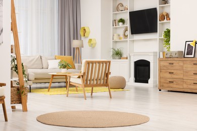 Photo of Spring atmosphere. Stylish room interior with cozy furniture in yellow and white colors