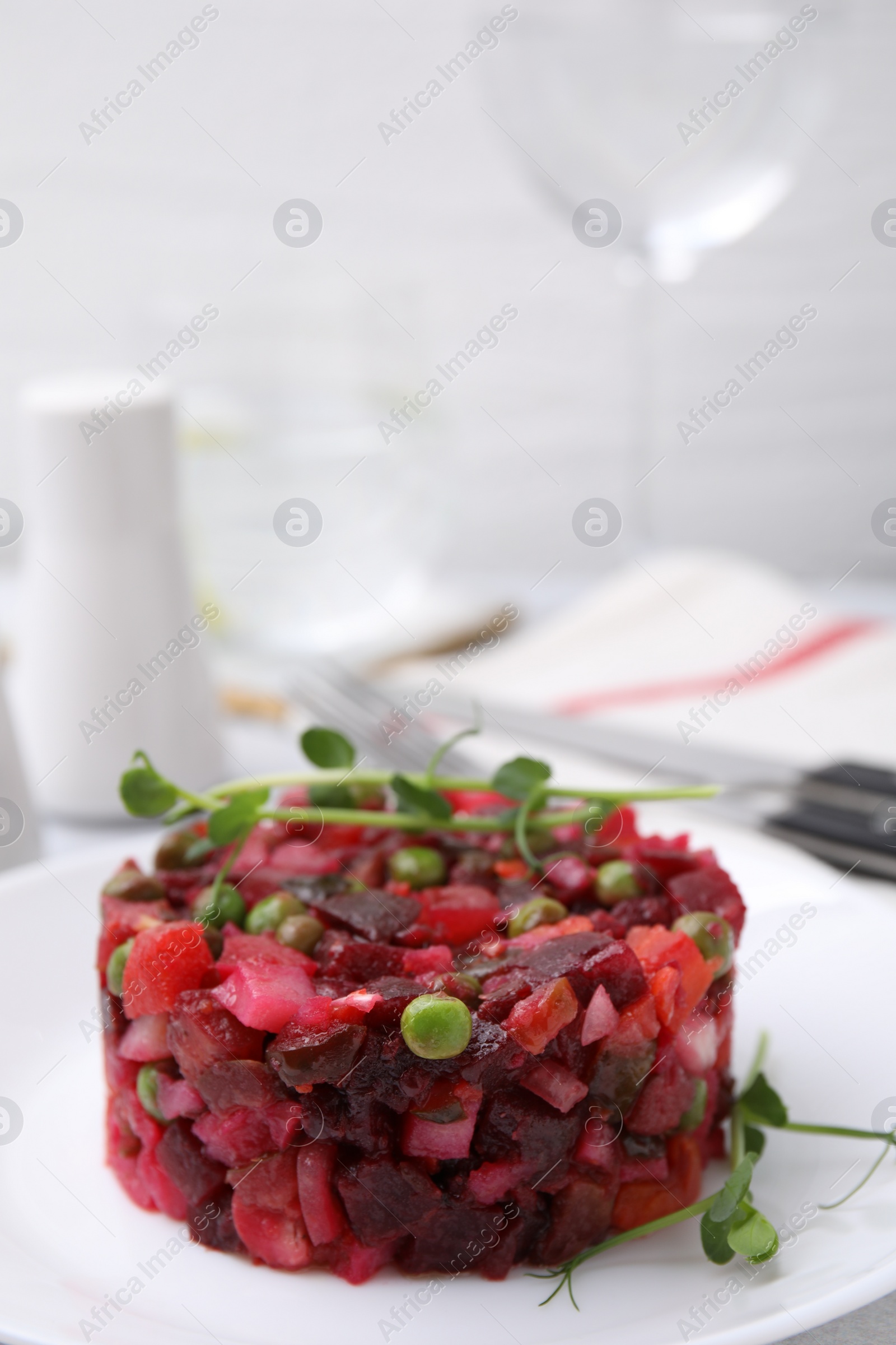 Photo of Delicious vinaigrette salad on white plate, closeup