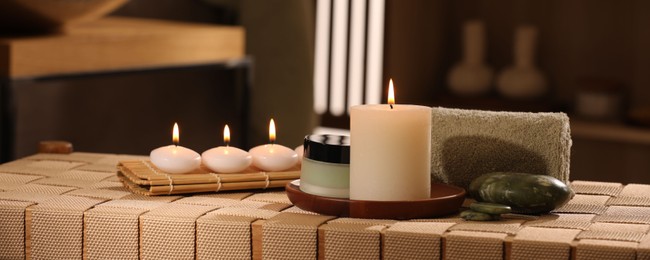 Beautiful composition with different spa products on wicker bench indoors