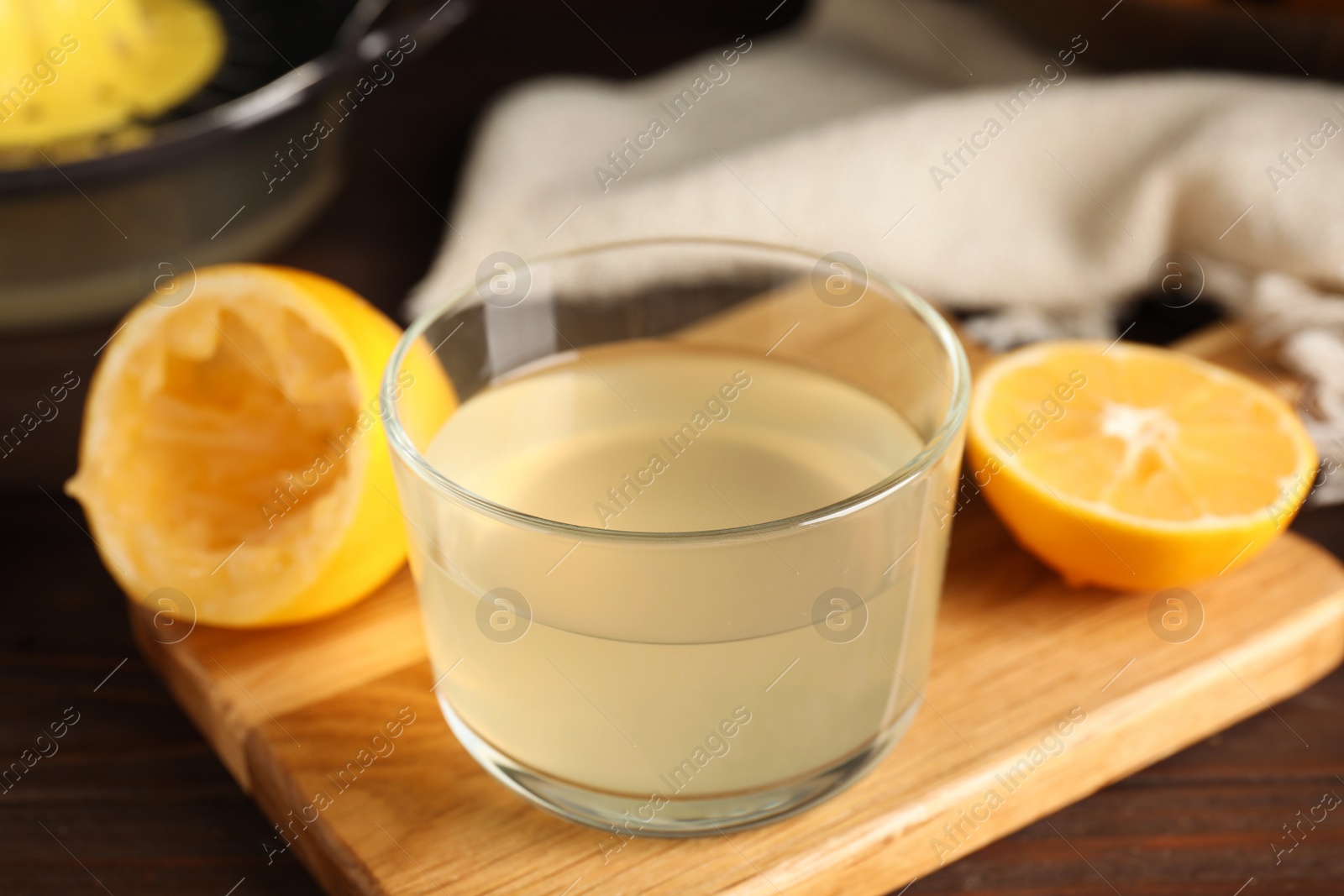 Photo of Freshly squeezed lemon juice in glass bowl on table