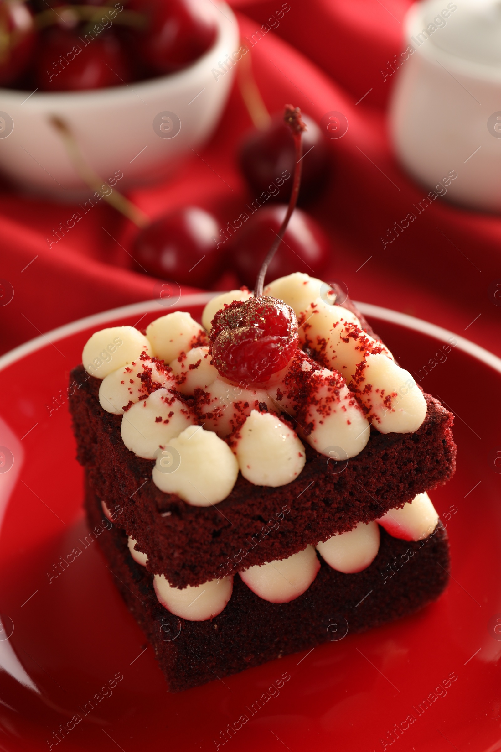 Photo of Piece of red velvet cake on plate, closeup