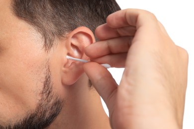 Photo of Man cleaning ears on white background, closeup