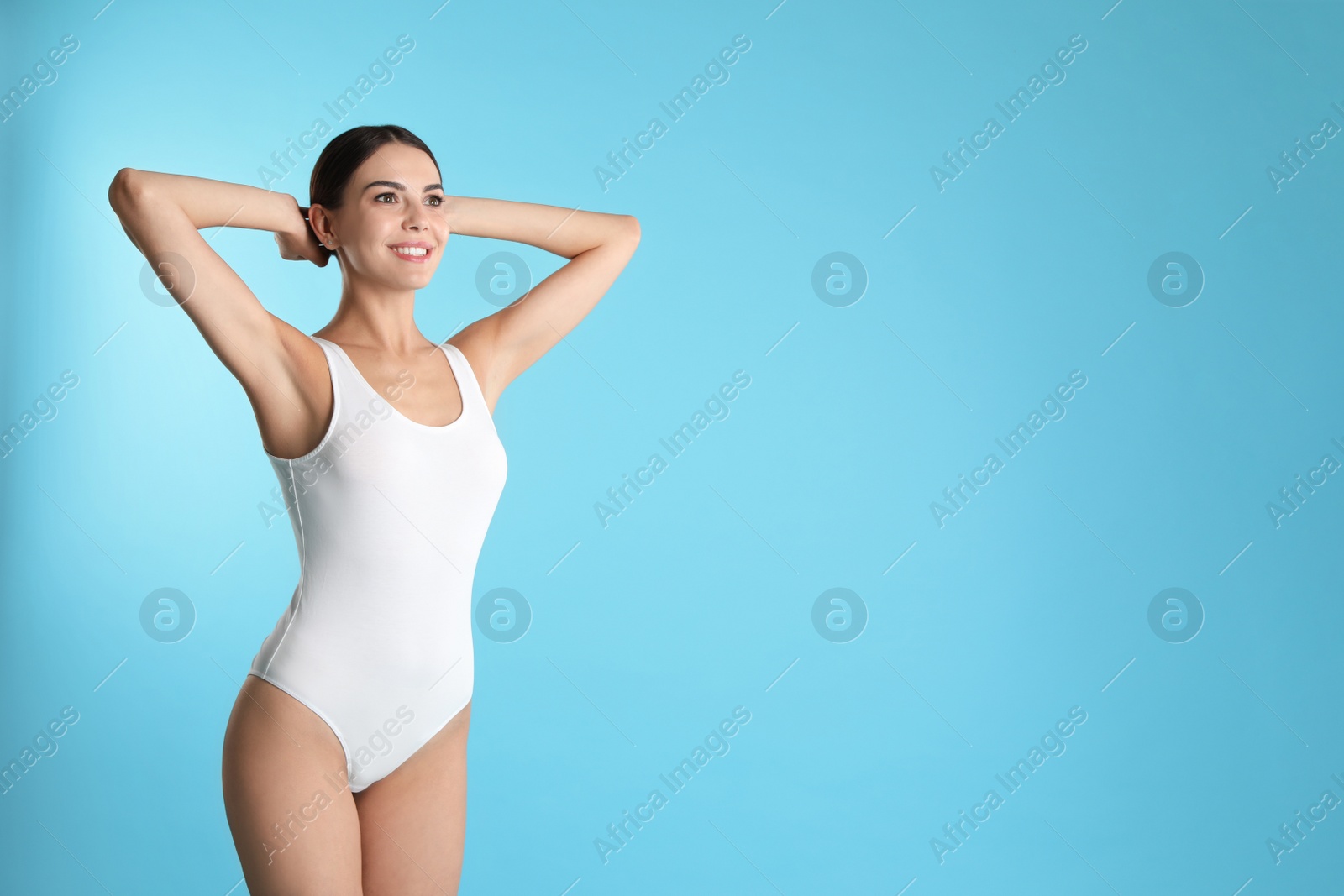 Photo of Portrait of attractive young woman with slim body in swimwear on color background. Space for text