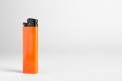 Stylish small pocket lighter on white background, space for text