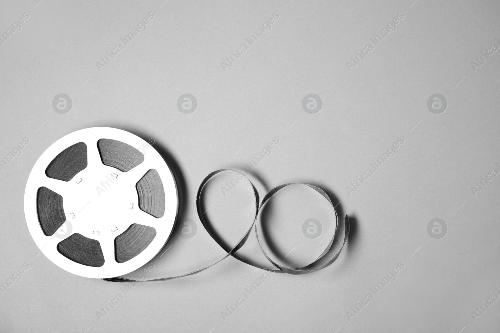 Photo of Movie reel on grey background, top view with space for text. Cinema production