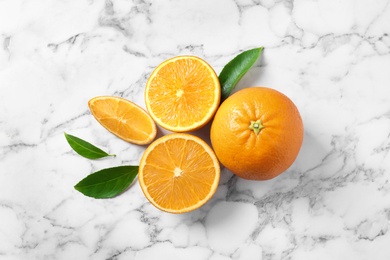 Flat lay composition with ripe oranges on marble background