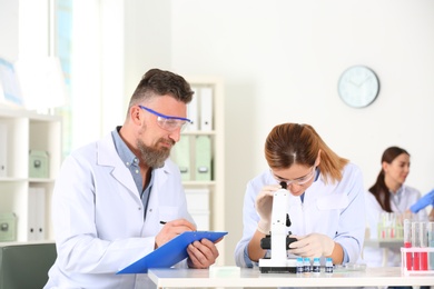 Scientists working in laboratory. Research and analysis