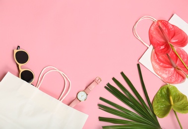 Photo of Stylish flat lay composition with shopping bags on color background