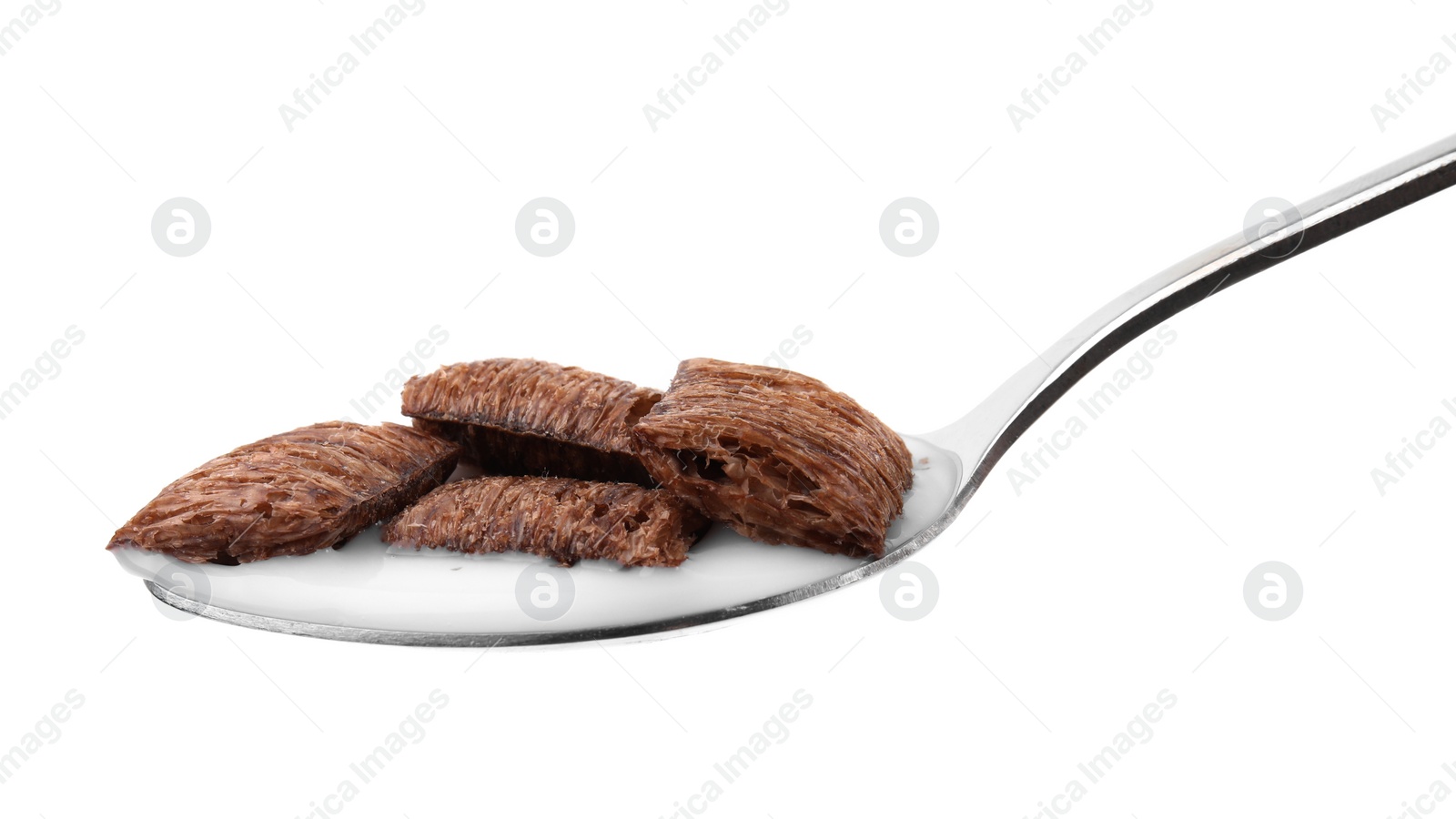 Photo of Chocolate cereal pads and milk in spoon isolated on white