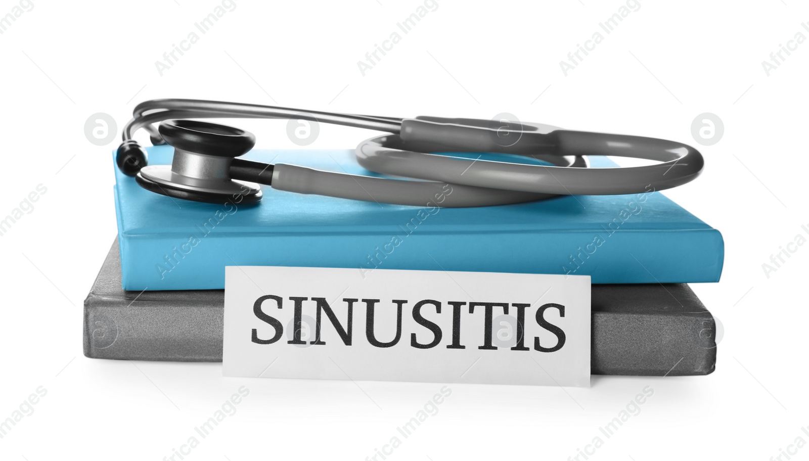 Photo of Card with word SINUSITIS, stethoscope and books on white background