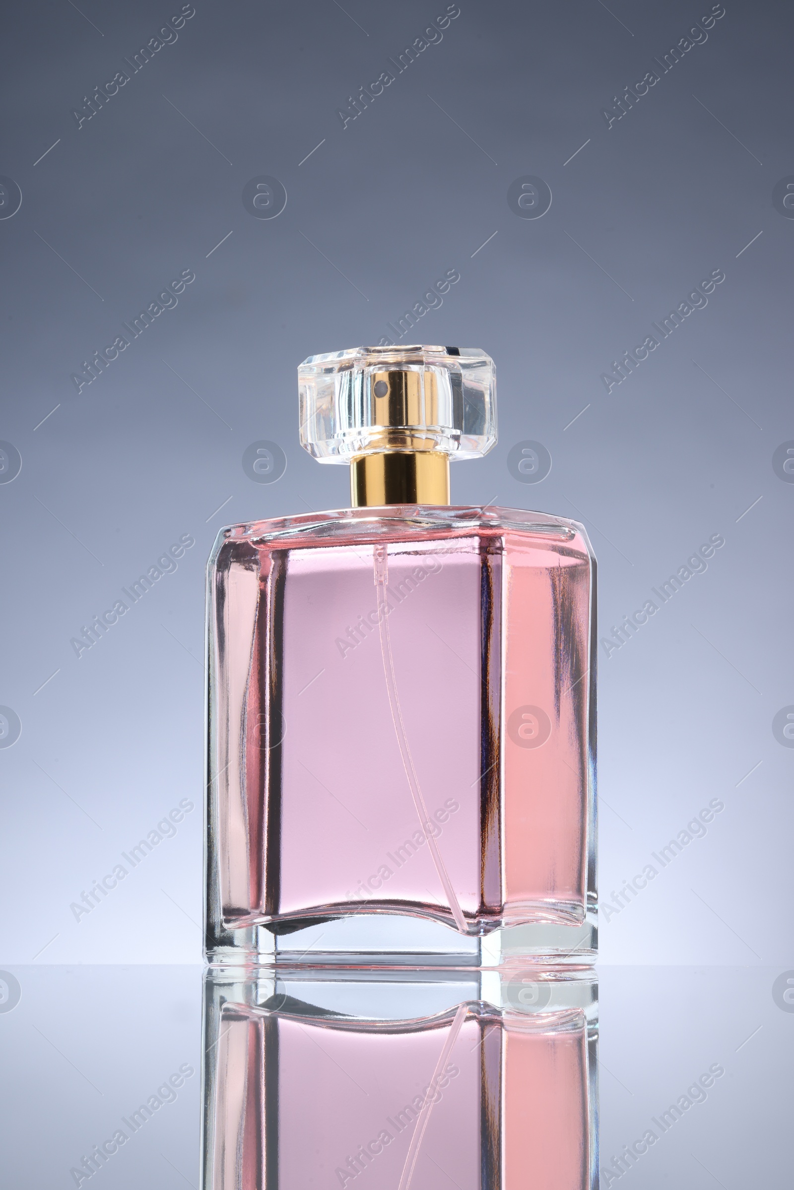 Photo of Luxury women's perfume in bottle on grey background