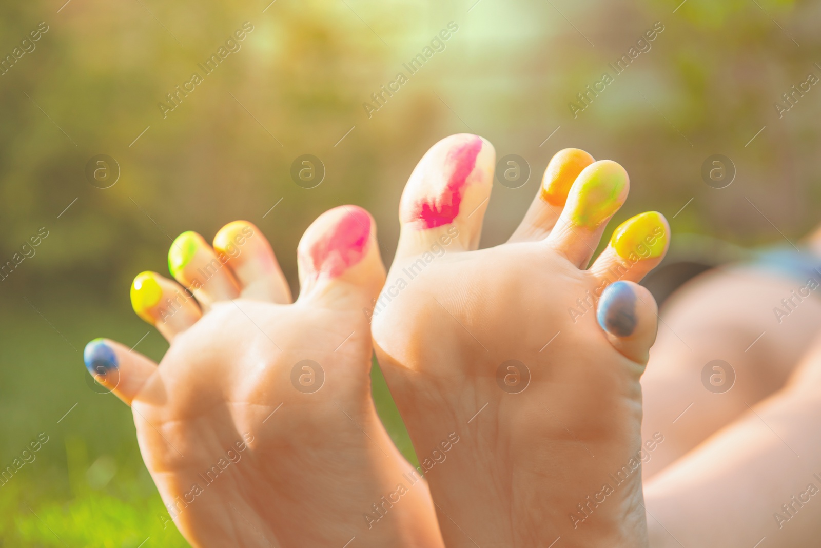 Photo of Teenage girl with painted toes outdoors, closeup