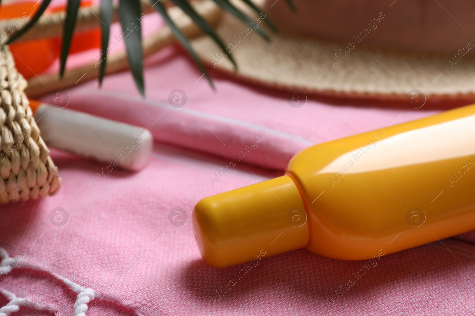 Photo of Sun protection product on towel, closeup view