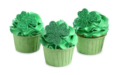 Photo of St. Patrick's day party. Tasty cupcakes with green clover leaf toppers and cream isolated on white