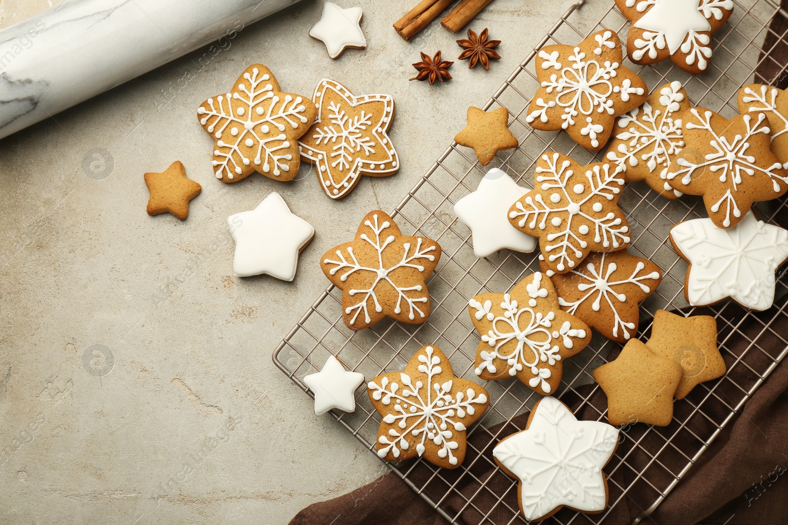 Photo of Tasty Christmas cookies with icing and spices on light table, flat lay. Space for text