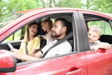 Photo of Happy family with children taking road trip together