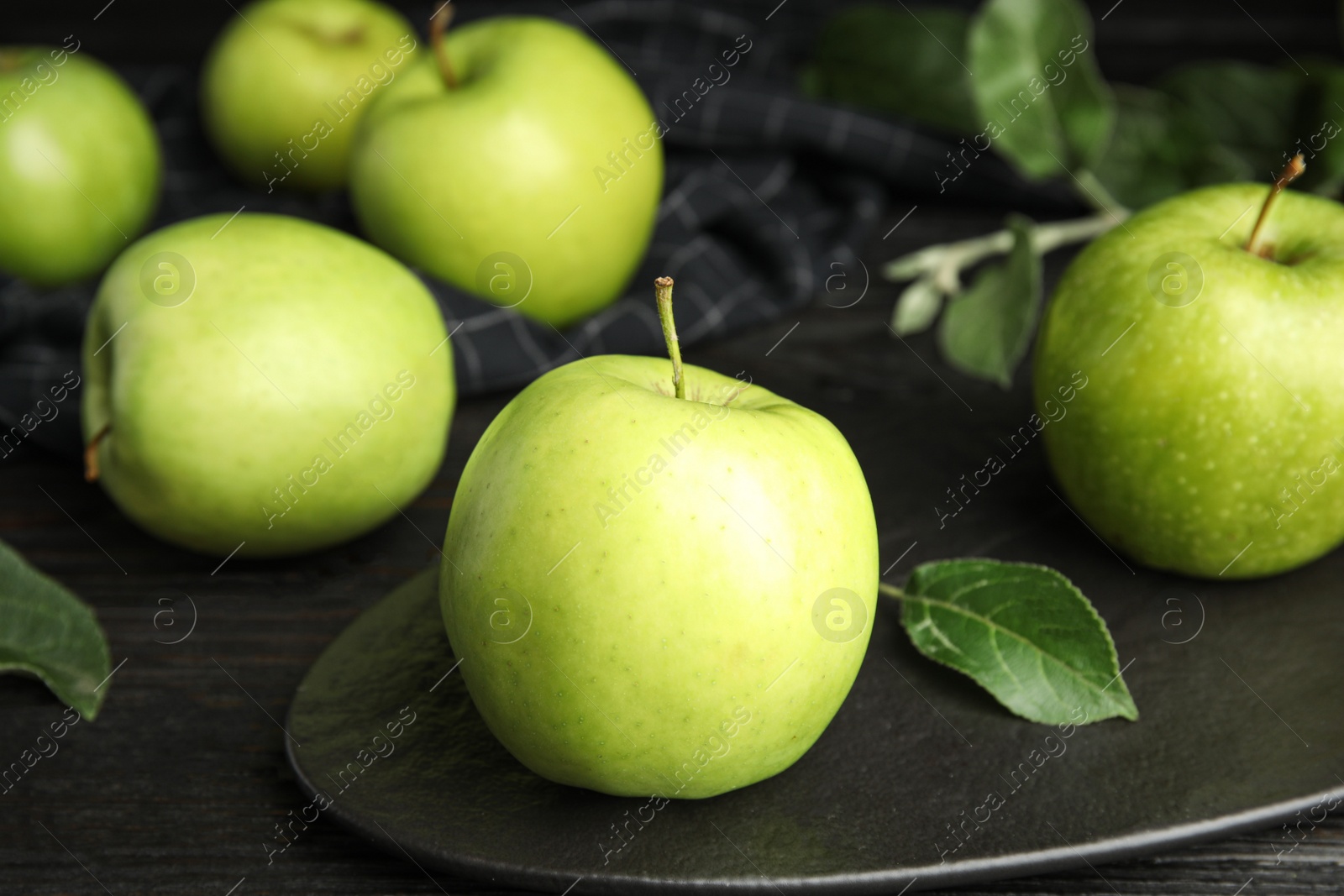 Photo of Fresh ripe green apples on black wooden table