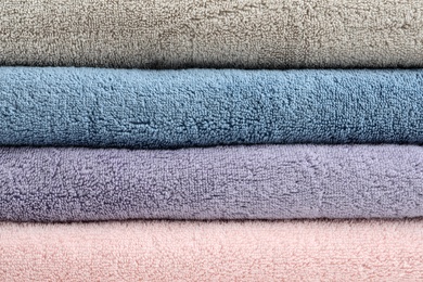 Stack of clean terry towels as background