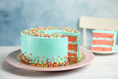 Photo of Cut fresh delicious birthday cake on table