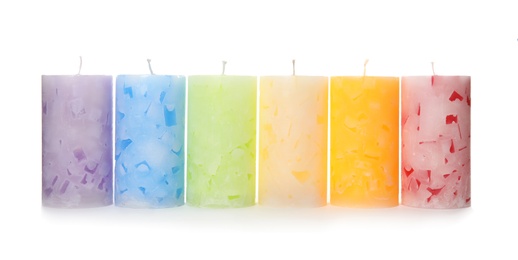 Photo of Six color wax candles on white background