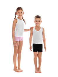 Cute little children in underwear on white background