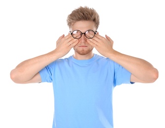 Photo of Young man with glasses covering eyes on white background