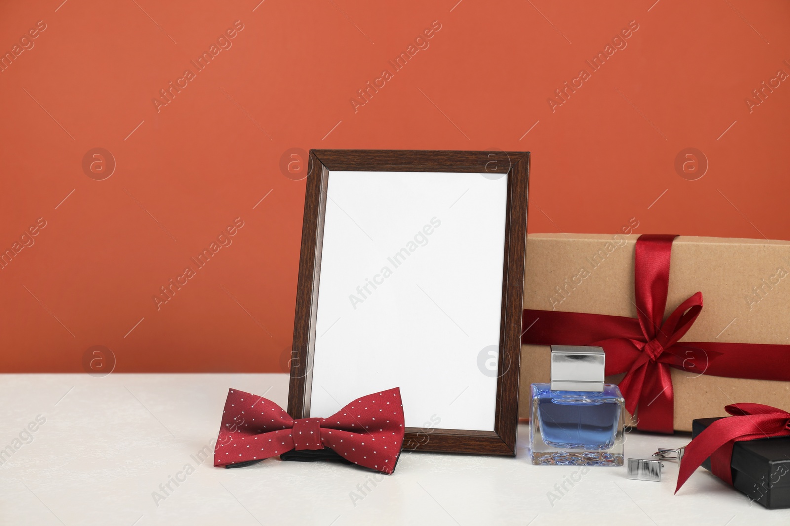 Photo of Happy Father's Day. Empty frame and presents on white table. Space for text
