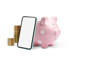 Image of Piggy bank with coins and smartphone on white background. Online banking