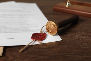 Image of Public notary. Document with wax stamp on wooden table, closeup