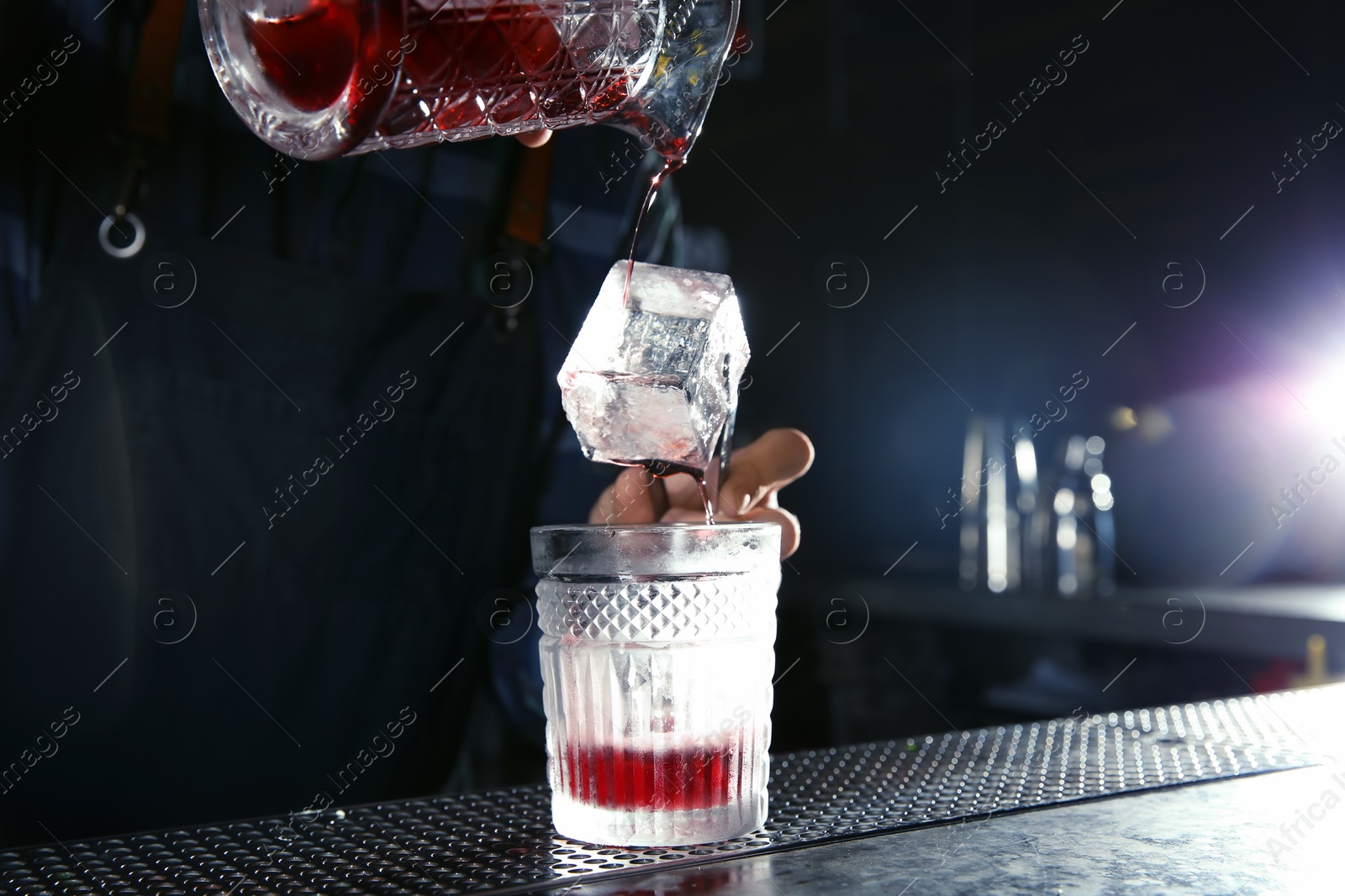 Photo of Barman making Red Russian cocktail at counter in pub, closeup. Space for text