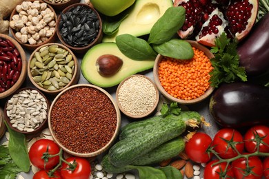 Different vegetables, seeds and fruits on grey table, flat lay. Healthy diet