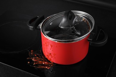 Photo of Dirty pot with lid on cooktop in kitchen