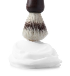 Shaving foam and brush on white background