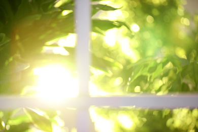 Photo of Blurred view through window on garden in morning