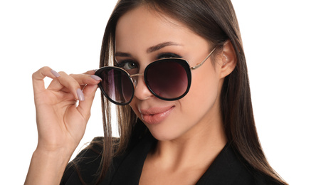 Beautiful young woman wearing sunglasses on white background, closeup