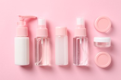 Cosmetic travel kit on pink background, flat lay. Bath accessories