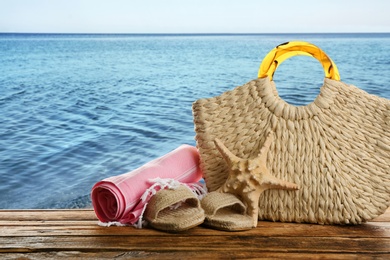 Image of Beach accessories on wooden surface near sea 