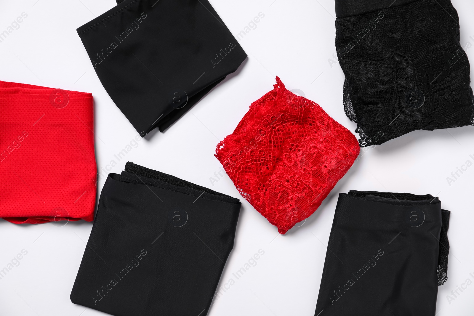 Photo of Stylish folded women's underwear on white background, flat lay